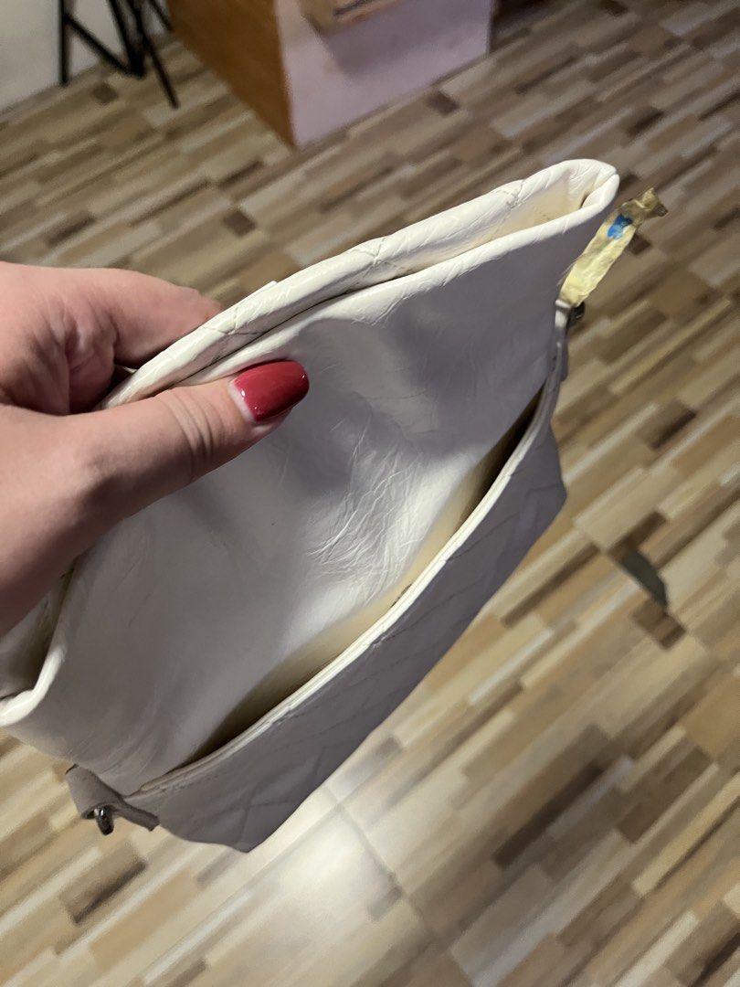 ORIGINAL Quilted Clutch Bag with Chain Strap (Category: Clutches) located in Quezon City. Submitted by rebagged.mnl (Listing ID 1461406055, Image 3). Description: - Chic white quilted clutch bag - Detachable chain strap included - Features 'ORIGINAL' brand logo on the front - Interior zippered pocket for essentials.