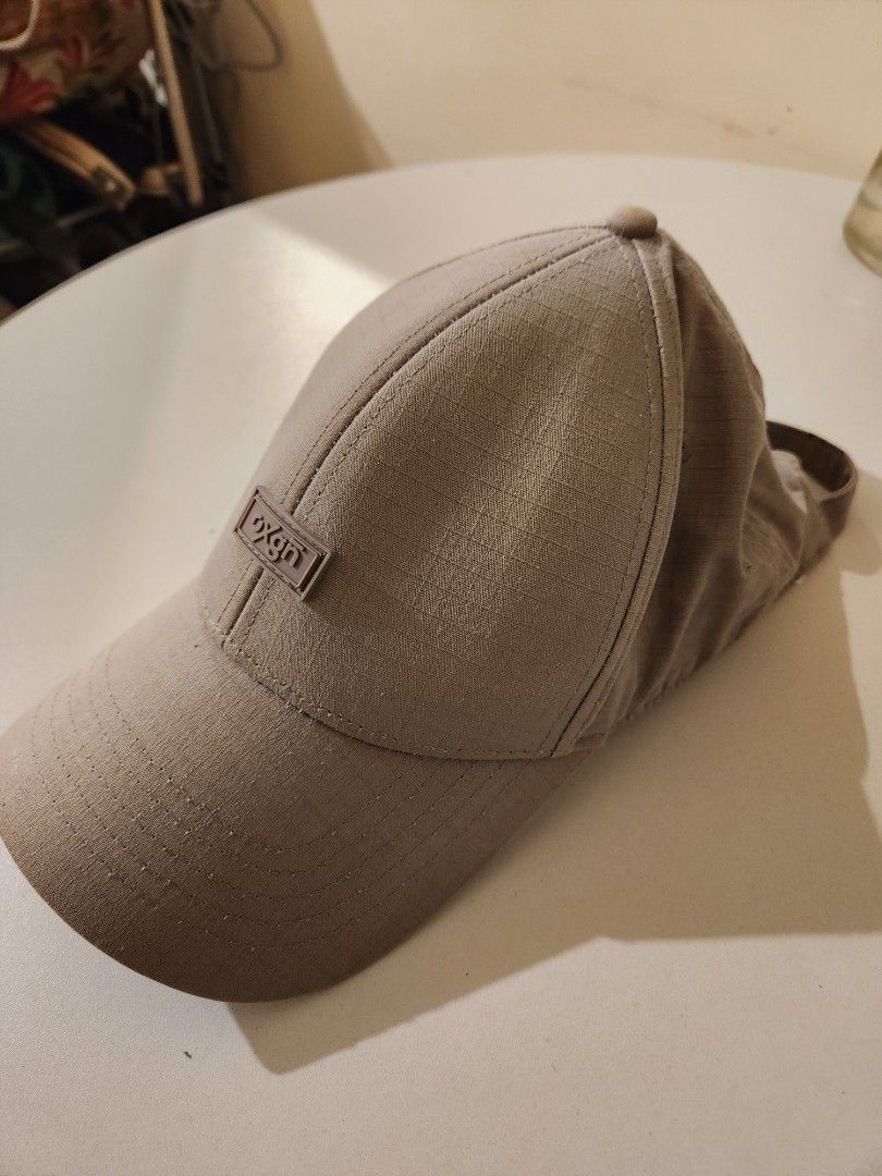OXGN Baseball Cap Tan One Size Fits All (Category: Caps & Hats) located in Manila. Submitted by azzamandi339507 (Listing ID 1461365990, Image 2). Description: - Brand: OXGN - Color: Gray - Style: Baseball Cap - Features: Textured fabric, small front logo detail - Fit: Adjustable strap at the back - Ideal for: Everyday wear, outdoor activities - color in pictures might vary due to lighting MOP: Gcash/Cash/Bank Transfer Meetup: Robinsons Galleria/S