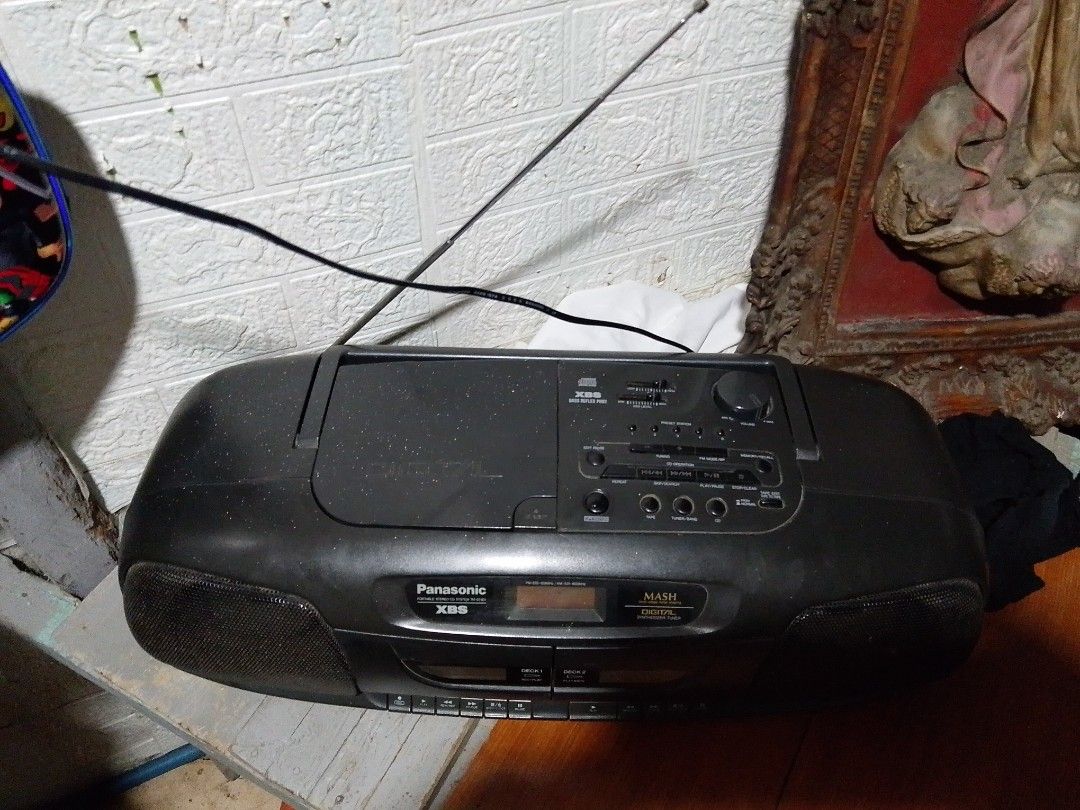 Panasonic boombox (Category: Vinyls) located in Quezon City. Submitted by mhond-ray192512 (Listing ID 1461438635, Image 2). Description: Vintage Panasonic RX-DT401 portable stereo boombox good condition. XBS (Extra Bass System) for enhanced low-frequency sound. MASH Digital synthesizer tuner for AM/FM radio. Dual cassette decks supporting tape playback and recording. Top-loading CD player compartment under the lid..