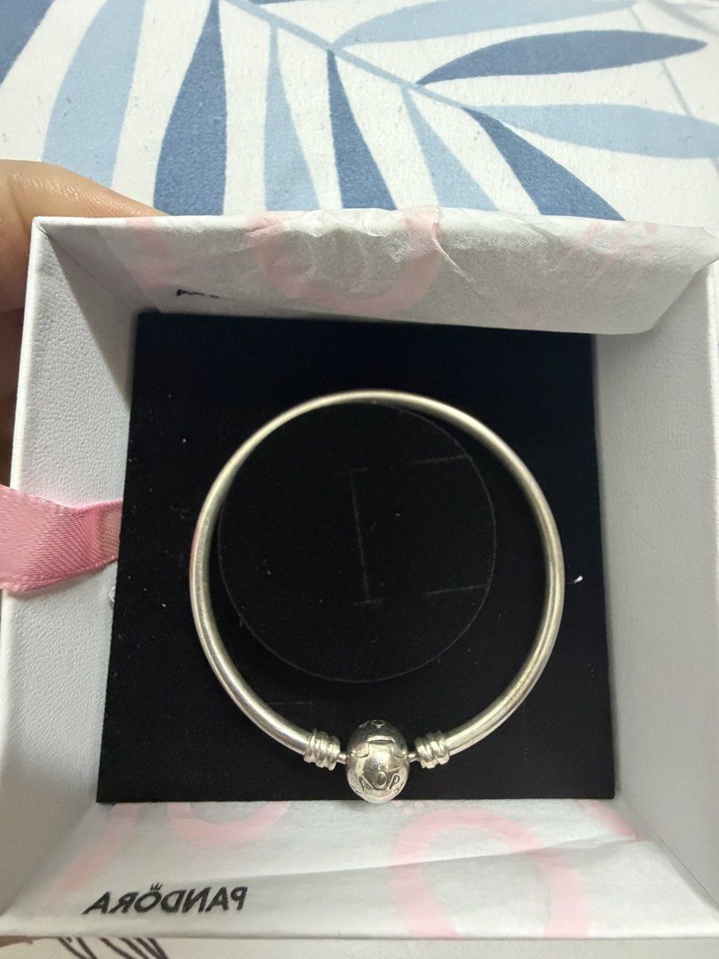 Pandora Sterling Silver Bangle Bracelet with Clasp (Category: Bracelets) located in Bocaue. Submitted by graceeshoppe (Listing ID 1461405110, Image 2). Description: - size 17cm. - Authentic Pandora sterling silver bangle bracelet - Features the classic Pandora logo clasp - Comes with original Pandora box and tissue paper - Ideal for showcasing your favorite Pandora charms - Ready for its new home Location: General Trias, Cavite .