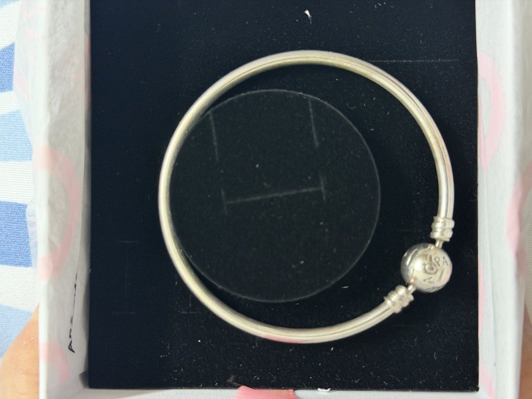 Pandora Sterling Silver Bangle Bracelet with Clasp (Category: Bracelets) located in Bocaue. Submitted by graceeshoppe (Listing ID 1461405110, Image 1). Description: - size 17cm. - Authentic Pandora sterling silver bangle bracelet - Features the classic Pandora logo clasp - Comes with original Pandora box and tissue paper - Ideal for showcasing your favorite Pandora charms - Ready for its new home Location: General Trias, Cavite .