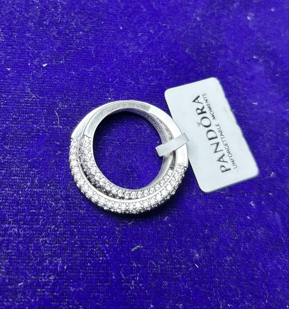 Pandora Sterling Silver Pave Ring (Category: Rings) located in Caloocan City. Submitted by berndale_closet (Listing ID 1461488141, Image 1). Description: - Genuine Pandora sterling silver ring - Features a beautiful crossover design with pave detailing - Versatile: great for stacking with other rings or wearing solo - Includes original tag - Adds a touch of sparkle to any outfit -size 56 or 7.5 -ring only, no other inclusions.