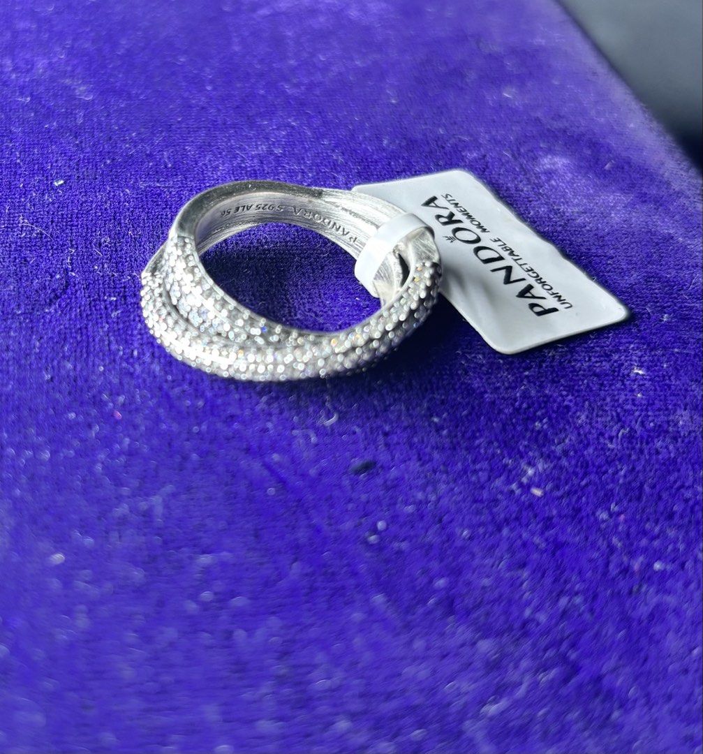 Pandora Sterling Silver Pave Ring (Category: Rings) located in Caloocan City. Submitted by berndale_closet (Listing ID 1461488141, Image 2). Description: - Genuine Pandora sterling silver ring - Features a beautiful crossover design with pave detailing - Versatile: great for stacking with other rings or wearing solo - Includes original tag - Adds a touch of sparkle to any outfit -size 56 or 7.5 -ring only, no other inclusions.