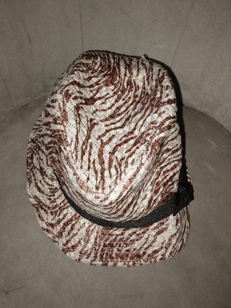 Patterned Straw Fedora Hat with Black Ribbon Bow (Category: Hats & Beanies) located in Binangonan. Submitted by yuristalin888 (Listing ID 1461381599, Image 3). Description: Add a chic, textured flair to your sunny-day wardrobe with this patterned straw fedora. Featuring a stylish interwoven design in earthy brown and cream tones, accented by a classic black ribbon band and a delicate side bow, this lightweight hat delivers a sophisticated twist o