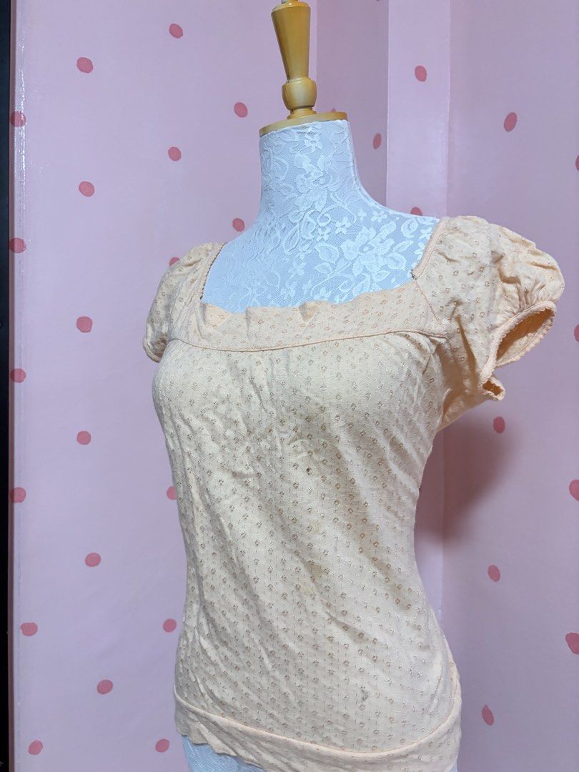 Peach Puff Sleeve Square Neck Top with Small Floral Pattern (Category: Blouses) located in Pagadian. Submitted by purewonderofsparkles (Listing ID 1461333311, Image 3). Description: - Cute peach top with short puff sleeves - Features a square neckline with ruffled trim - All-over small floral pattern with a subtle shimmer - Minor flaw: tiny hole on the front (visible in the last photo) - Ideal for casual outfits.
