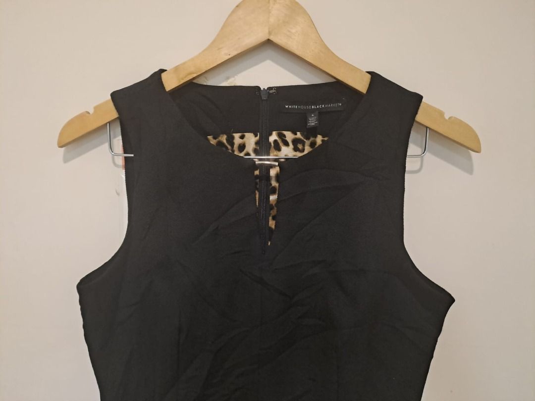 Peplum sleeveless (Category: Sleeveless) located in Mandaluyong City. Submitted by epicowl-c93c (Listing ID 1461347416, Image 1). Description: This is a sleek sleeveless peplum top from the brand White House Black Market. It features a tailored silhouette, a tiered layered bodice, and a distinct keyhole cutout neckline that highlights an inner leopard/animal print trim .