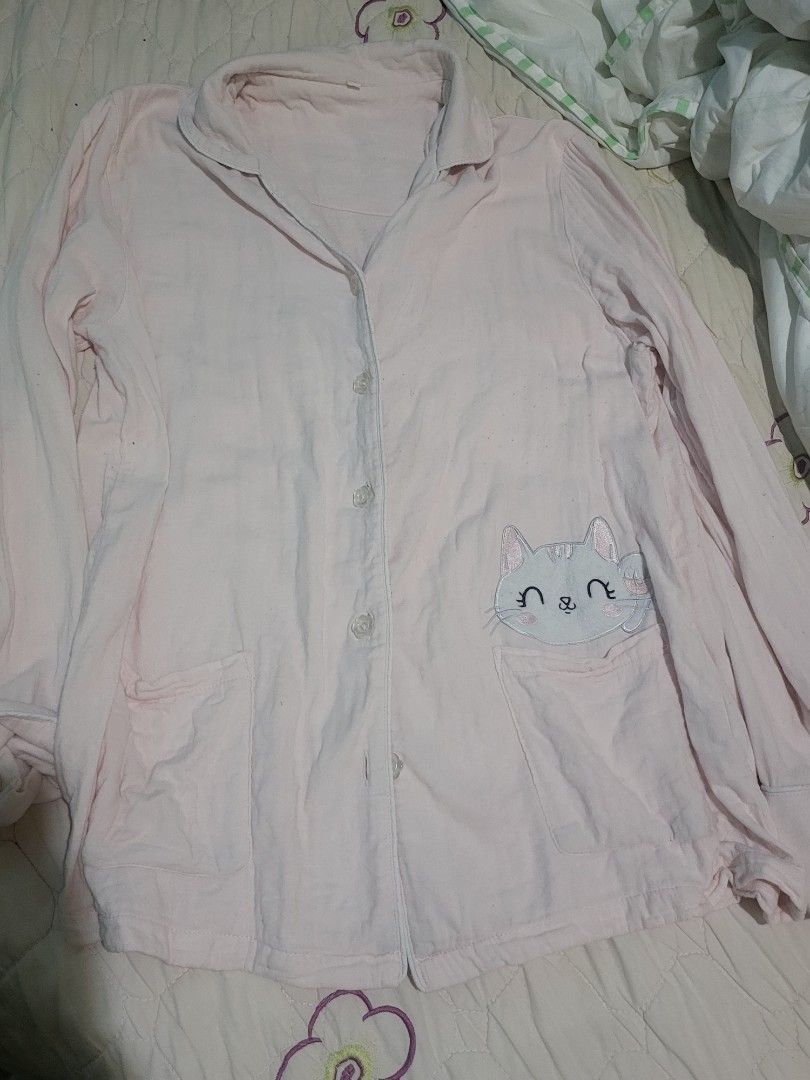 Pink Cat Pajama Top (Category: Undergarments & Loungewear) located in Manila. Submitted by calmmountain.887b60 (Listing ID 1461335048, Image 1). Description: - Adorable pink pajama top - Features a cute embroidered cat face on the chest pocket - Long sleeves for extra warmth - Easy button-up front closure - Made from soft, comfortable fabric - Perfect for sleeping or lounging - A must-have for any cat lover!.