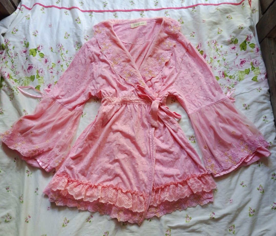Pink Heart Pattern Kimono Robe with Lace Trim (Category: Undergarments & Loungewear) located in Kalibo. Submitted by chinxecloset (Listing ID 1461498272, Image 1). Description: - Adorable pink kimono robe - Features a subtle all-over heart pattern - Stylish bell sleeves with sheer lace trim - Elegant ruffled lace hem - Comes with a matching tie belt - Versatile: Ideal for lounging at home or as a chic cover-up.