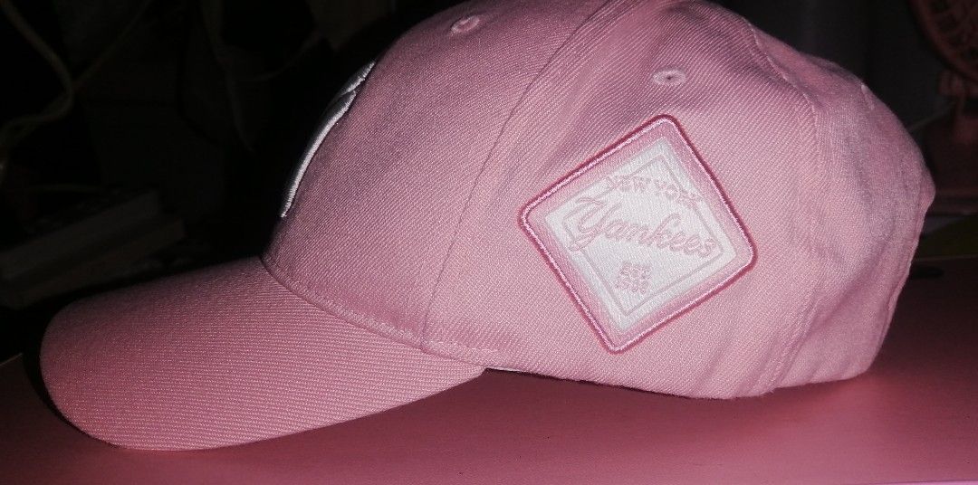 Pink New York Yankees MLB Baseball Cap (Category: Caps & Hats) located in Quezon City. Submitted by rolenalma (Listing ID 1461559572, Image 3). Description: - Classic pink Yankees cap - Features embroidered NY logo on the front - 'New York Yankees Est. 1903' diamond patch on the side - MLB logo on the back - Adjustable strap for a comfortable fit - Perfect for any baseball fan!.