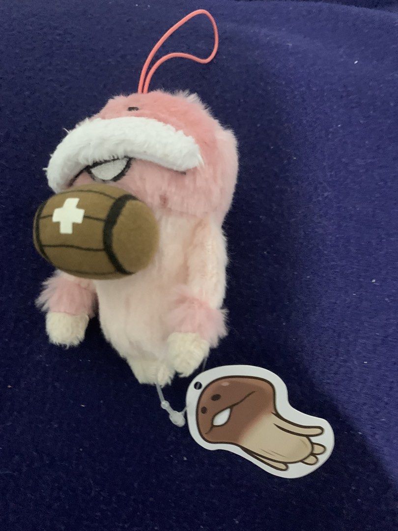Pink Plush Keychain with Barrel Charm (Category: Plushies & Soft Toys) located in Pasig City. Submitted by miswatamita (Listing ID 1461410099, Image 1). Description: - Adorable pink plush keychain. - Features a small barrel with a white cross. - Includes a tag with a cute mushroom character. - Perfect accessory for bags or keys. - A must-have for fans of cute plushies..