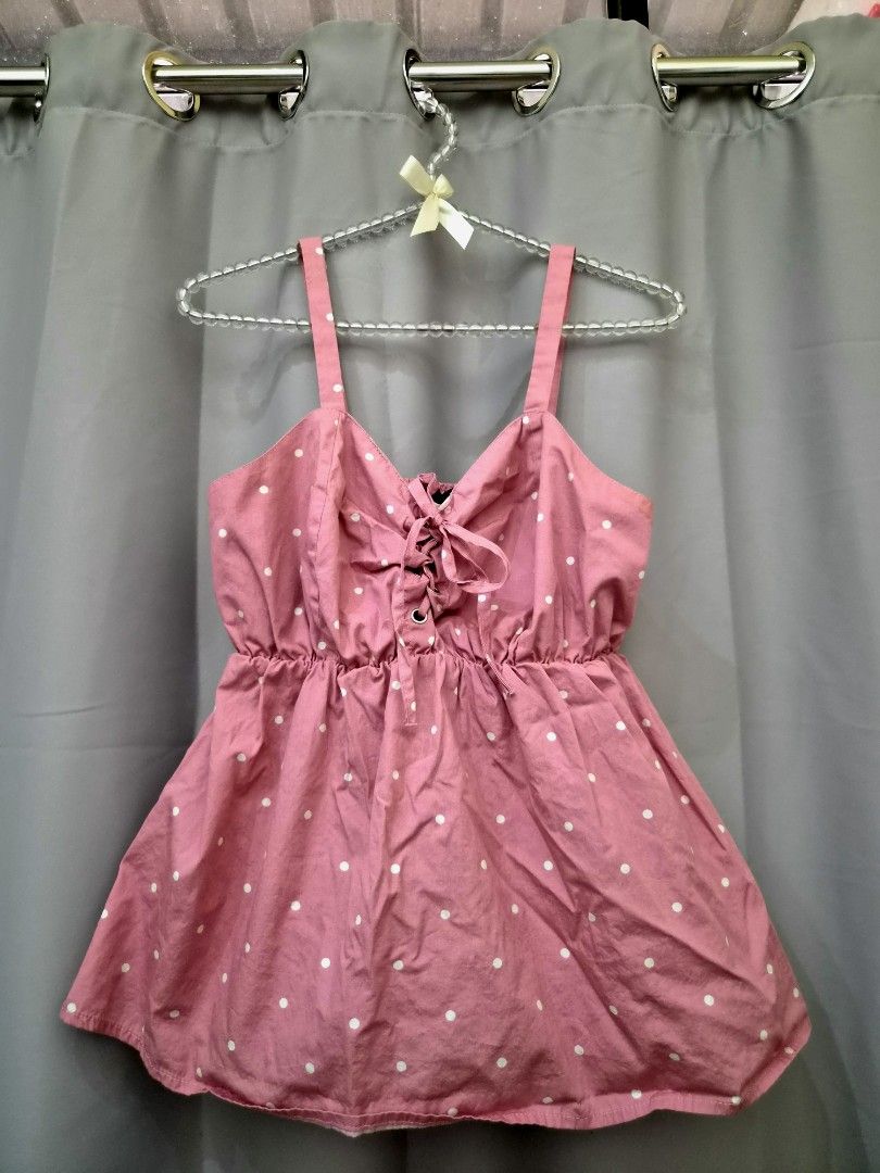 Pink Polka Dot Lace-Up Top (Category: Sleeveless) located in Manila. Submitted by manoygoodies (Listing ID 1461401219, Image 1). Description: - Adorable pink dress with white polka dots - Features a flattering lace-up front - Comfortable elasticated waist for a perfect fit - Flared hem for a playful silhouette - Stylish strappy design - Ideal for casual days, picnics, or a fun outing.