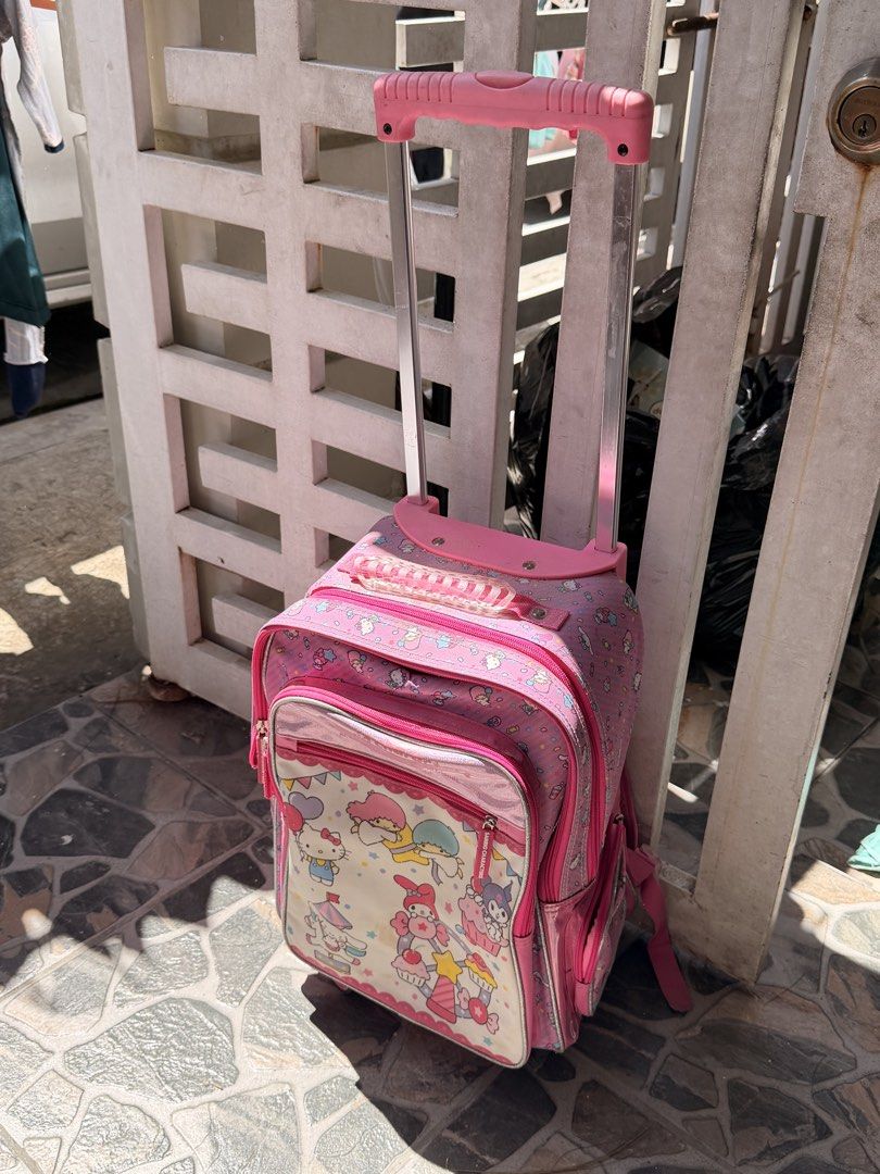 Pink Sanrio Hello Kitty Trolley (Category: Stationery & School Supplies) located in Rizal. Submitted by leahann (Listing ID 1461339760, Image 2). Description: - Adorable pink rolling backpack featuring Kitty and other Sanrio characters. - Equipped with a retractable handle and wheels for effortless portability. - Includes a spacious main compartment and a convenient front pocket. - Perfect for school or travel adventures..