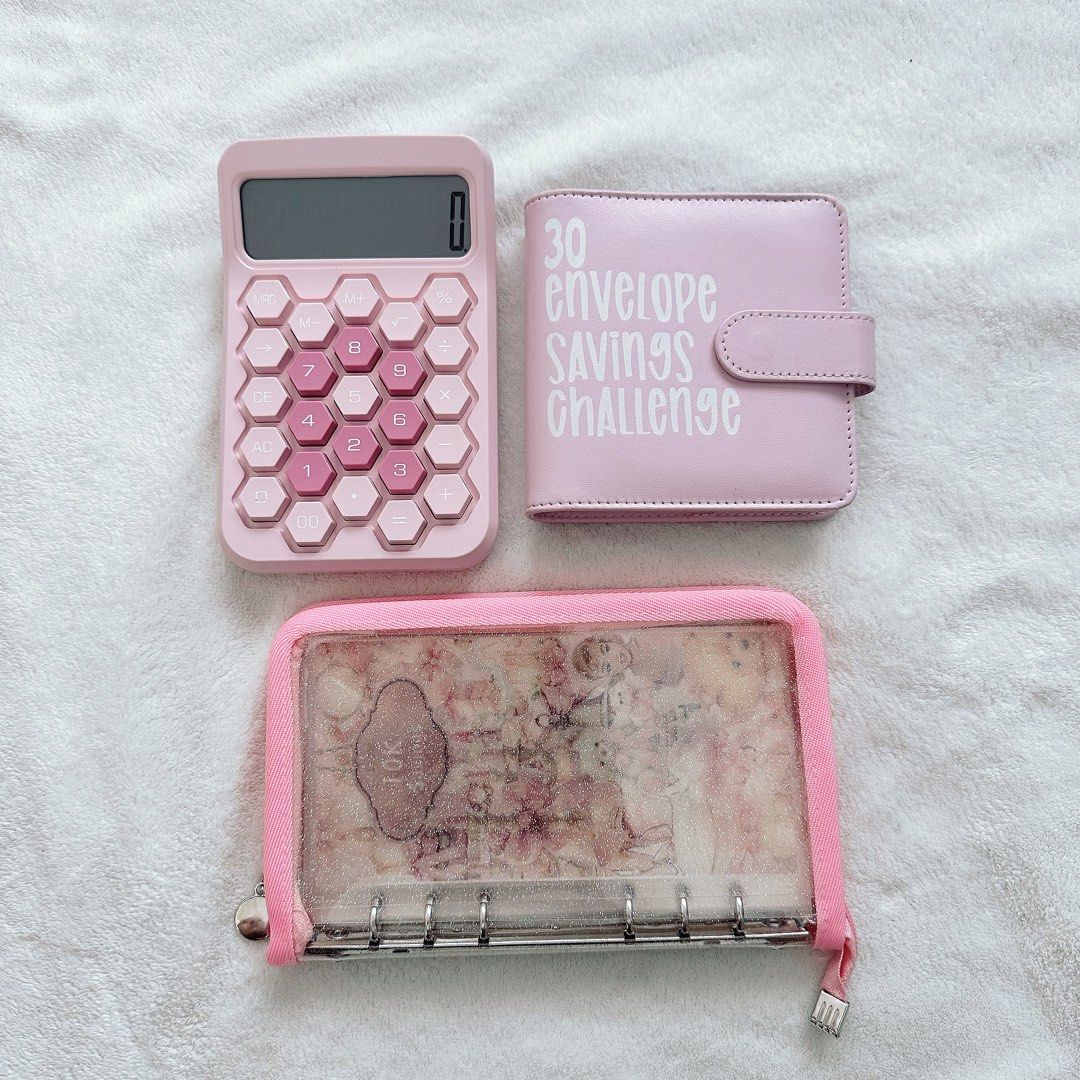 Pink Savings Challenge Kit with Calculator & Binder (Category: Other Stationery & Craft) located in Cebu City. Submitted by jycn.p (Listing ID 1461346549, Image 1). Description: - Adorable pink savings challenge kit. - Includes a hexagonal calculator. - Comes with a binder featuring 30 envelope savings challenge inserts. - Separate zipper pouch for cash or cards. - Ideal for budgeting and kickstarting your savings goals..