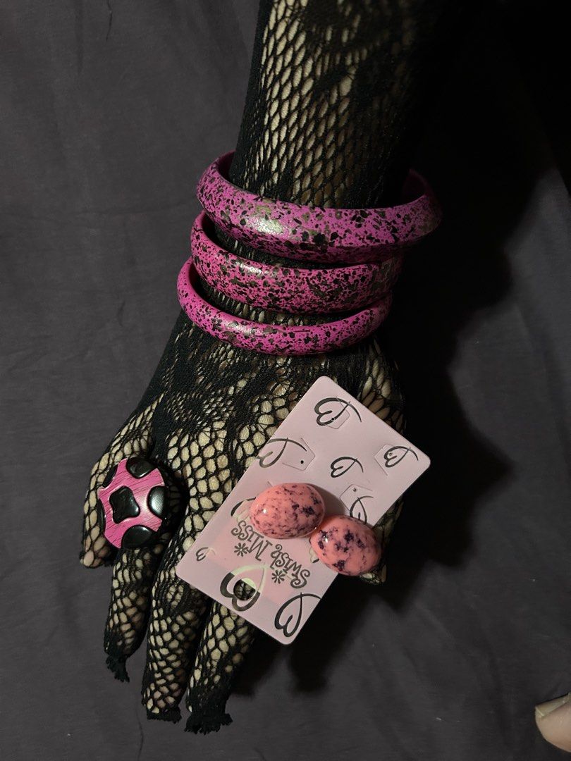 Pink Splatter Bangles, Ring, and Swish Miss Earrings Set (Category: Earrings) located in Pasig City. Submitted by mixpicks (Listing ID 1461364895, Image 1). Description: - Funky pink splatter bangles (stackable!) - Matching pink splatter ring with black details - Pair of pink speckled oval earrings from Swish Miss - Perfect for adding a playful pop of color to any outfit - All pieces feature unique, playful designs - Take all.