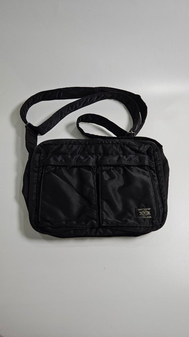 Porter Yoshida & Co. Tank Bag (Category: Sling Bags) located in Alfonso. Submitted by jbcamet (Listing ID 1461491496, Image 1). Description: - Durable black Porter shoulder bag - Made from tough nylon material - Multiple compartments for organized storage - Includes clear pockets and a main zippered section - Adjustable strap for comfortable carrying - Equipped with reliable YKK zippers - Ideal for everyday use or travel adventures.