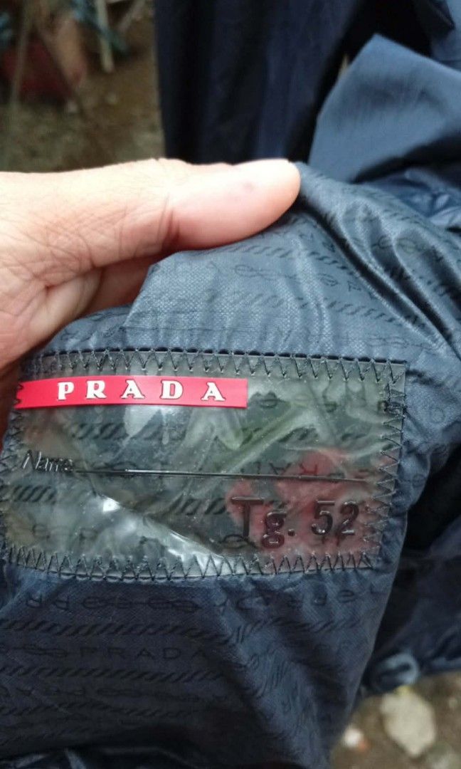Prada Nylon Jacket Triangle Logo ( Authentic ) (Category: Coats, Jackets and Outerwear) located in Barotac Nuevo. Submitted by john.pritz (Listing ID 1461439831, Image 2). Description: Prada Nylon Jacket Triangle Logo ( Authentic ) as new condi no issue no runs no pinhole Size 52 on tag Width 23 Length 28.