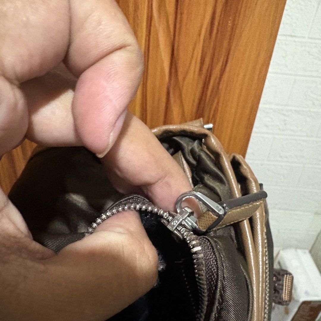 Prada Nylon Messenger Bag Khaki Brown (Category: Luxury Bags & Wallets) located in Carmen. Submitted by rr_thrifts (Listing ID 1461354280, Image 3). Description: - Prada messenger bag - Color: Khaki green nylon with brown leather trim - Features multiple compartments (inside and out) - Smooth working zippers - Adjustable strap for comfort - Ideal for everyday use - lampo zip - missing white tag - As is.