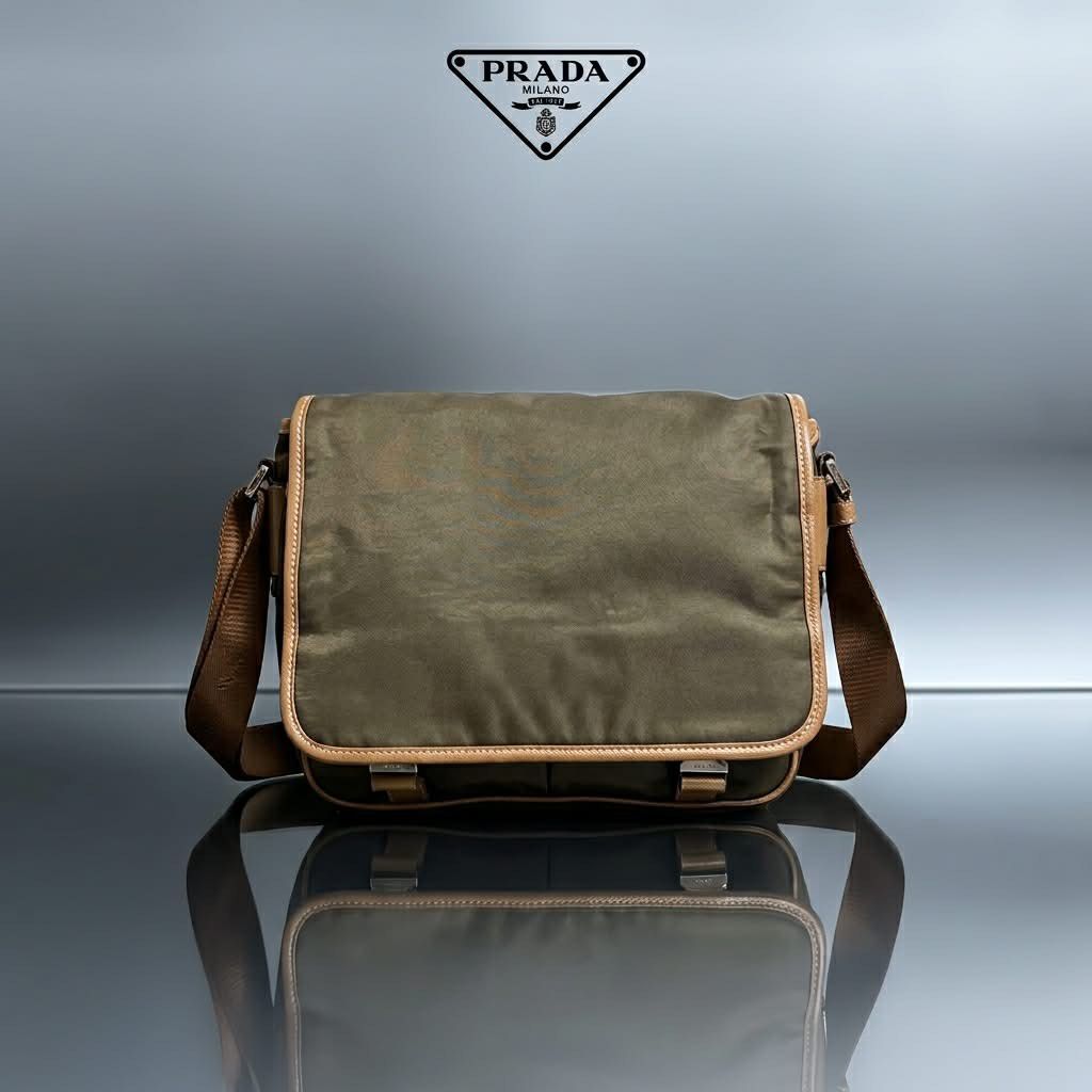 Prada Nylon Messenger Bag Khaki Brown (Category: Luxury Bags & Wallets) located in Carmen. Submitted by rr_thrifts (Listing ID 1461354280, Image 1). Description: - Prada messenger bag - Color: Khaki green nylon with brown leather trim - Features multiple compartments (inside and out) - Smooth working zippers - Adjustable strap for comfort - Ideal for everyday use - lampo zip - missing white tag - As is.