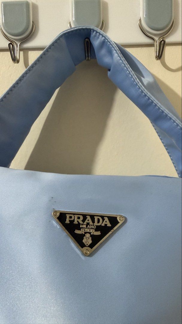 Prada Nylon Mini Bag Light Blue (Category: Purses & Pouches) located in Rizal. Submitted by lovegclothingph (Listing ID 1461479156, Image 2). Description: - Light blue Prada mini bag - Durable nylon material - Chic side drawstring detail - Comfortable handle for easy carrying - Ideal for your daily essentials - With minimal stains - No sling included - RFS: Decluttering.