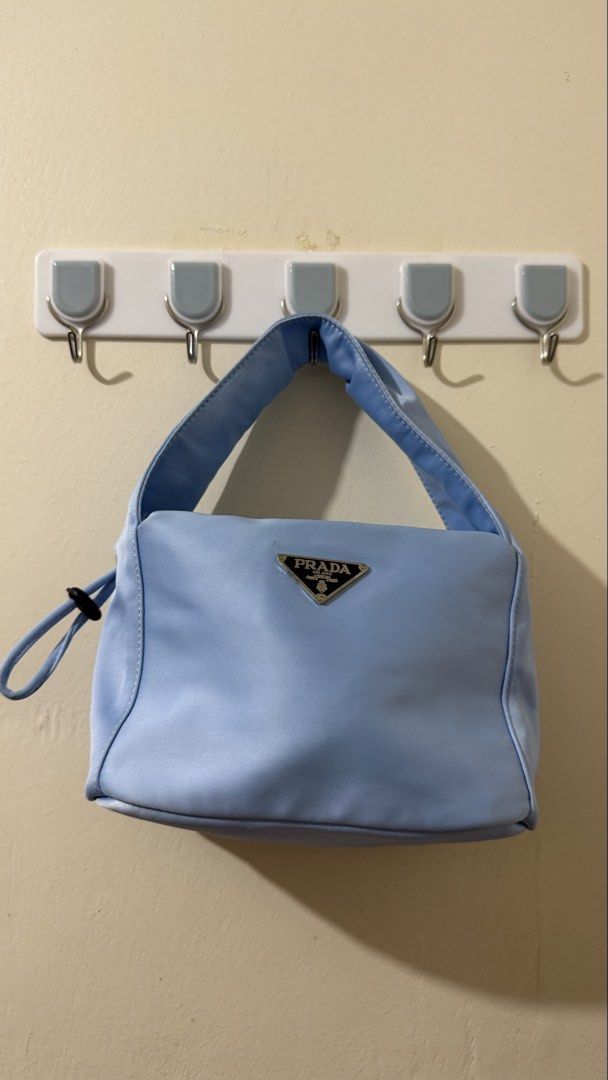 Prada Nylon Mini Bag Light Blue (Category: Purses & Pouches) located in Rizal. Submitted by lovegclothingph (Listing ID 1461479156, Image 1). Description: - Light blue Prada mini bag - Durable nylon material - Chic side drawstring detail - Comfortable handle for easy carrying - Ideal for your daily essentials - With minimal stains - No sling included - RFS: Decluttering.