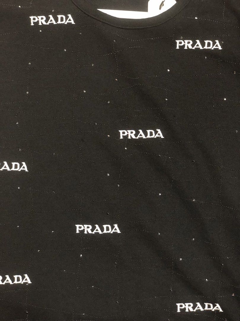 PRADA TEE (Category: Luxury Apparel) located in Baguio. Submitted by bilikabow (Listing ID 1461507086, Image 3). Description: PRADA black short-sleeve t-shirt accented with scattered rhinestones and repeated Prada logo prints. For her 17x20 .