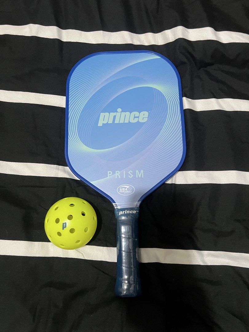Prince Prism Pickleball Paddle and Ball Set (Category: Racket and Ball Sports) located in Pasig City. Submitted by alon02 (Listing ID 1461348558, Image 2). Description: - Prince Prism pickleball paddle - Includes one pickleball - Ideal for playing pickleball - Available colors: Lime Green or Blue - Perfect for personal use or as a gift - Feel free to ask any questions!.