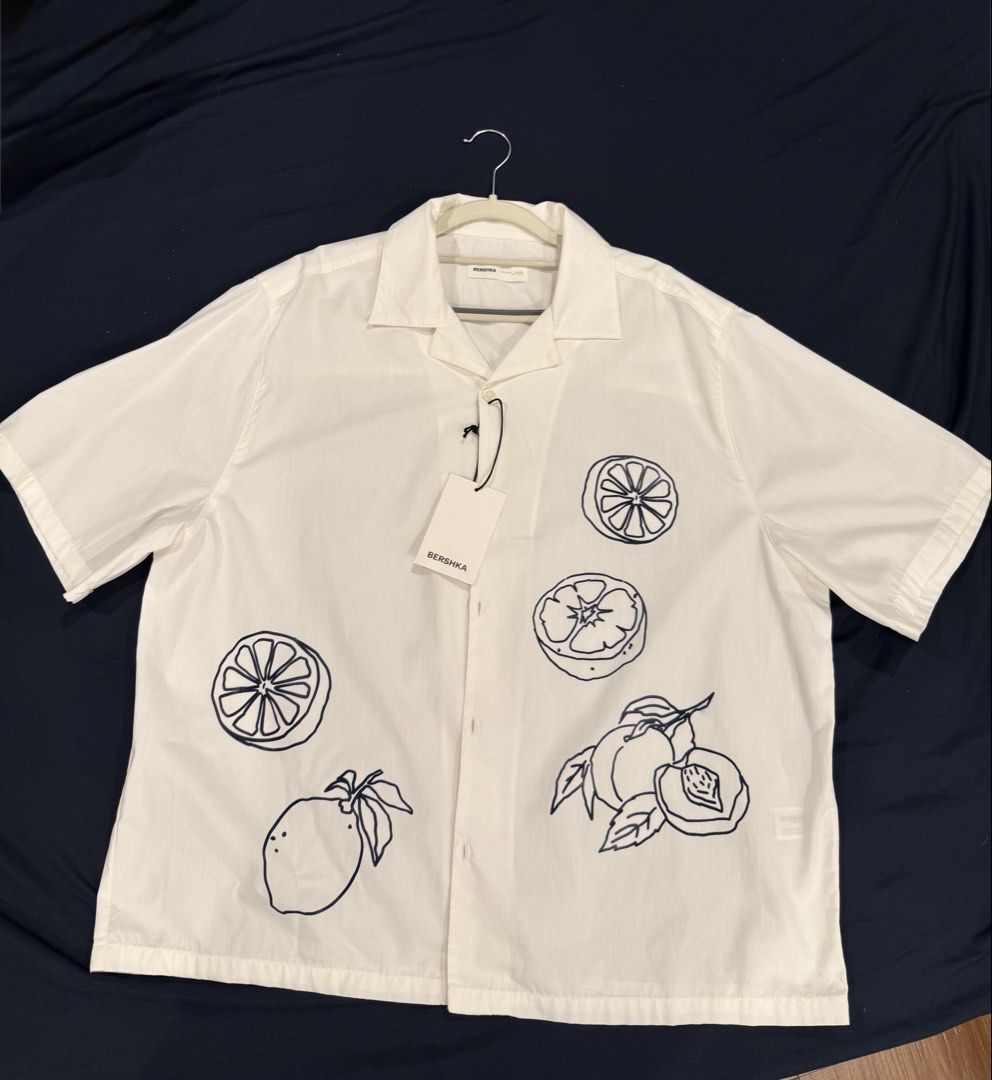 Printer Polo (BERSHKA) (Category: Tshirts & Polo Shirts ) located in Manila. Submitted by kx.declutter (Listing ID 1461344050, Image 2). Description: FOR SALE 🤍 BERSHKA Printed Short-Sleeve Polo Brand: BERSHKA Condition: Brand New / Never Used, with tags Size: L (EUR/USA) / MEX 40 Original Price: ₱2,795 Selling Price: ₱2,500 only ✨ Clean white button-down with unique hand-drawn fruit graphic prints ✨ Relaxed short-sleeve fit ✨ Perfect for casual
