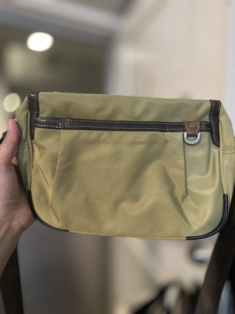 Progress Nylon and Leather Crossbody Bag (Category: Cross-body Bags) located in Mandaluyong City. Submitted by TheWeekendProject (Listing ID 1461520862, Image 1). Description: - Khaki green crossbody bag - Brown leather trim - Buckle detail on front flap - Adjustable brown strap for comfortable wear - Spacious interior for essentials - Minor signs of use - Ideal for everyday use.