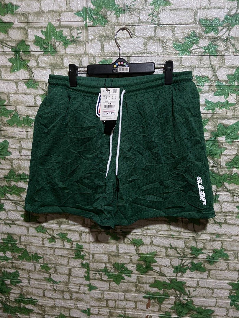 Pull & Bear NFL New York Jets Green Shorts (Category: Shorts) located in Davao. Submitted by mengsmixitems (Listing ID 1461340418, Image 2). Description: - Brand: Pull & Bear - Color: Green - Design: Features New York Jets NFL logo on the leg - Fit: Drawstring waist for adjustable comfort - Usage: Ideal for casual wear or sports activities - Style: Team apparel shorts.