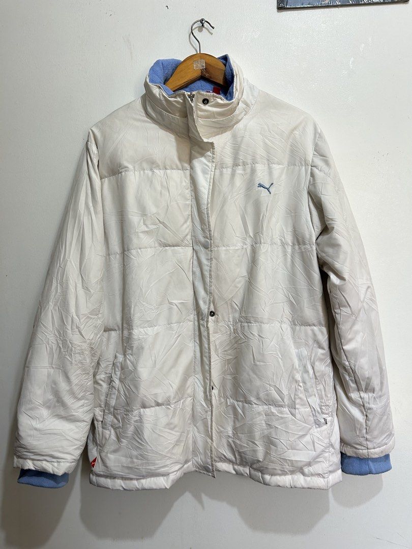 Puma Puffer Jacket Cream Blue (Category: Coats, Jackets and Outerwear) located in Calbayog City. Submitted by thrift.bucks101 (Listing ID 1461372642, Image 1). Description: - Authentic White Cream-colored Puma puffer jacket - Flawless, crisp condition -Good as new - Zipper and snap button closure - Two side pockets with zippers - Inner lining features a subtle Puma logo pattern - Ideal for cooler weather -DIMES: L - 29 | W - 20.