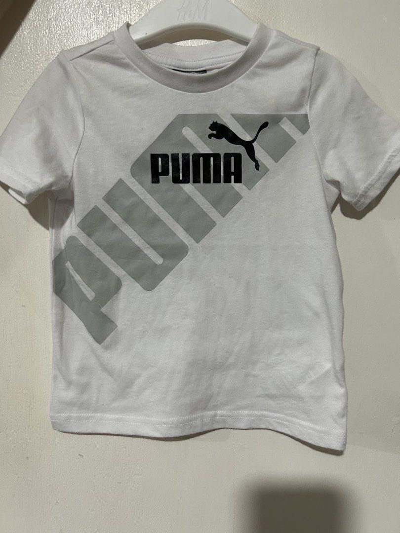 Puma White T-shirt with Grey Logo (Category: Babies & Kids Fashion) located in Caloocan City. Submitted by datumaootl13467 (Listing ID 1461534334, Image 1). Description: - White Puma t-shirt for kids - Classic Puma logo in grey and black - Short sleeves and crew neck - Ideal for everyday wear - Easily pairs with shorts or jeans.