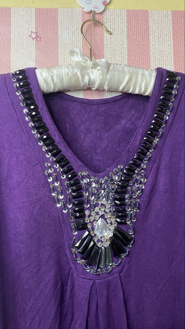 Purple beaded top (Category: Shirts) located in President Roxas. Submitted by starksandmoon_ii (Listing ID 1461397796, Image 2). Description: - Chic purple short-sleeved t-shirt - Flattering V-neckline - Eye-catching black and silver embellishments - Elegant pleating detail on the front - Versatile for dressing up or down.