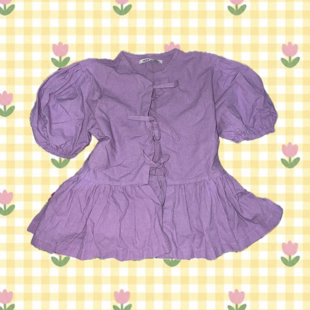 Purple Puff Sleeve Tie Front Peplum Top (Category: Blouses) located in Manila. Submitted by fayevoritegoods (Listing ID 1461476523, Image 1). Description: - Adorable purple top with charming puff sleeves. - Features a flattering tie detail in the front. - Stylish ruffled peplum hem for a feminine touch. - Simple and elegant band neckline. - Estimated size: Small to Medium. - Perfect for dressing up or down – great for any occasion!.