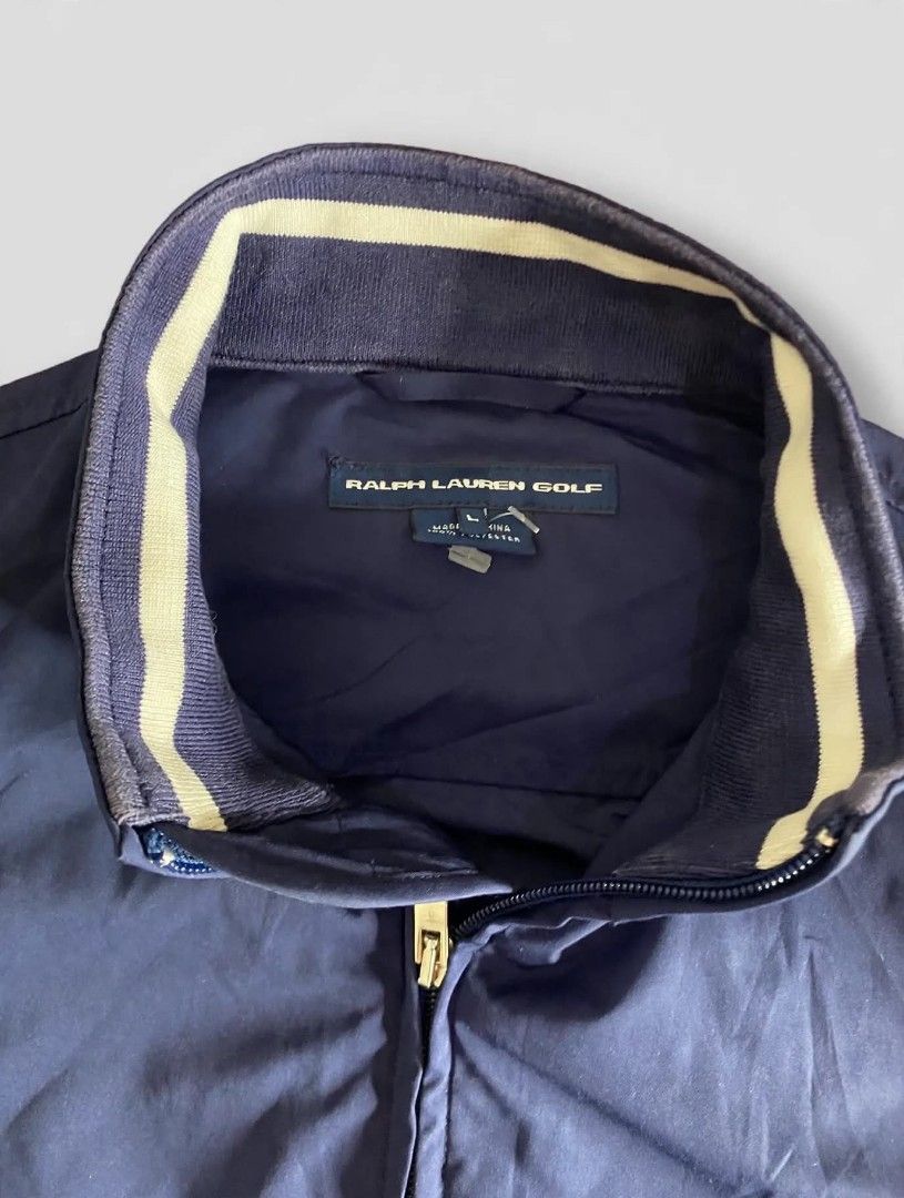 Ralph Lauren Golf Navy Blue Zip-Up Jacket (Category: Coats, Jackets and Outerwear) located in Bansalan. Submitted by thriftyzzz (Listing ID 1461473689, Image 3). Description: - Navy blue Ralph Lauren Golf jacket - Full zip closure - Front pockets - Adjustable waist straps - Ribbed collar detail - Ideal for layering or light weather - Easy to pack and wear.