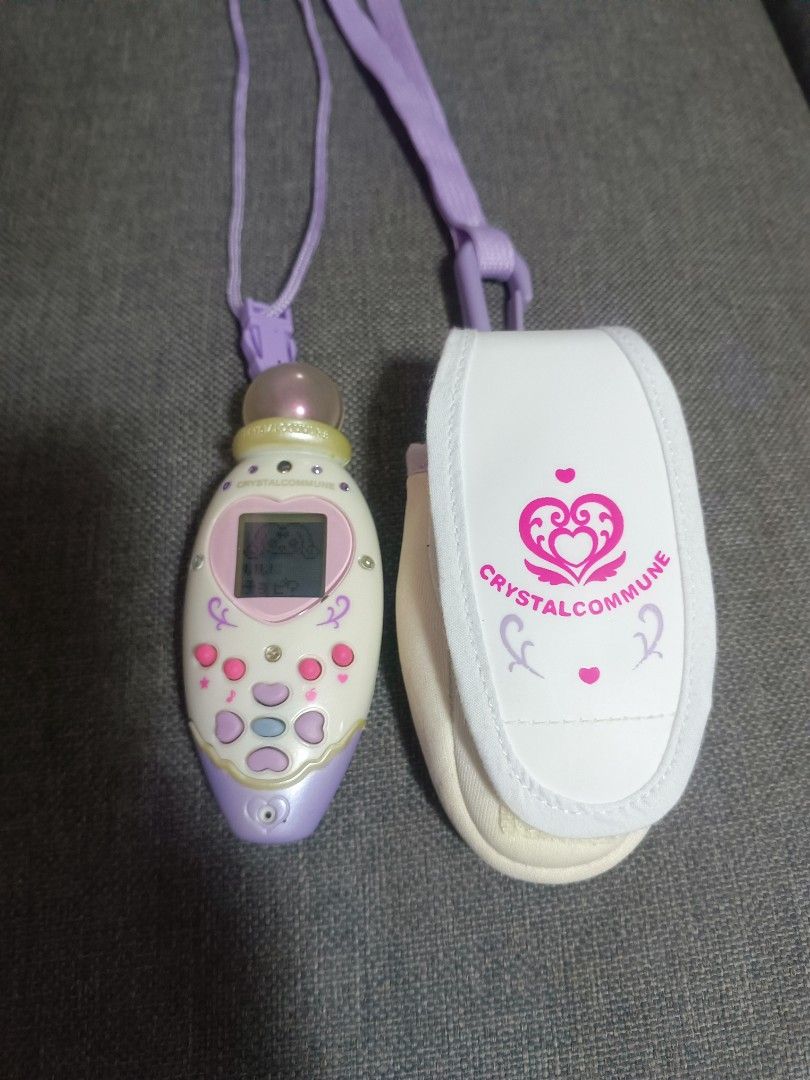 Rare Precure Crystal Commune BANDAI (Category: Designer & Blind Box Toys) located in Manila. Submitted by mateochest99469 (Listing ID 1461460139, Image 1). Description: Selling a highly sought-after vintage anime magical girl transformation item/virtual pet from the 2006 franchise Futari wa Pretty Cure Splash Star.This set is incredibly rare to find alongside its dedicated matching fabric carrier pouch! ✨ What’s Included:Crystal Commune Main Unit
