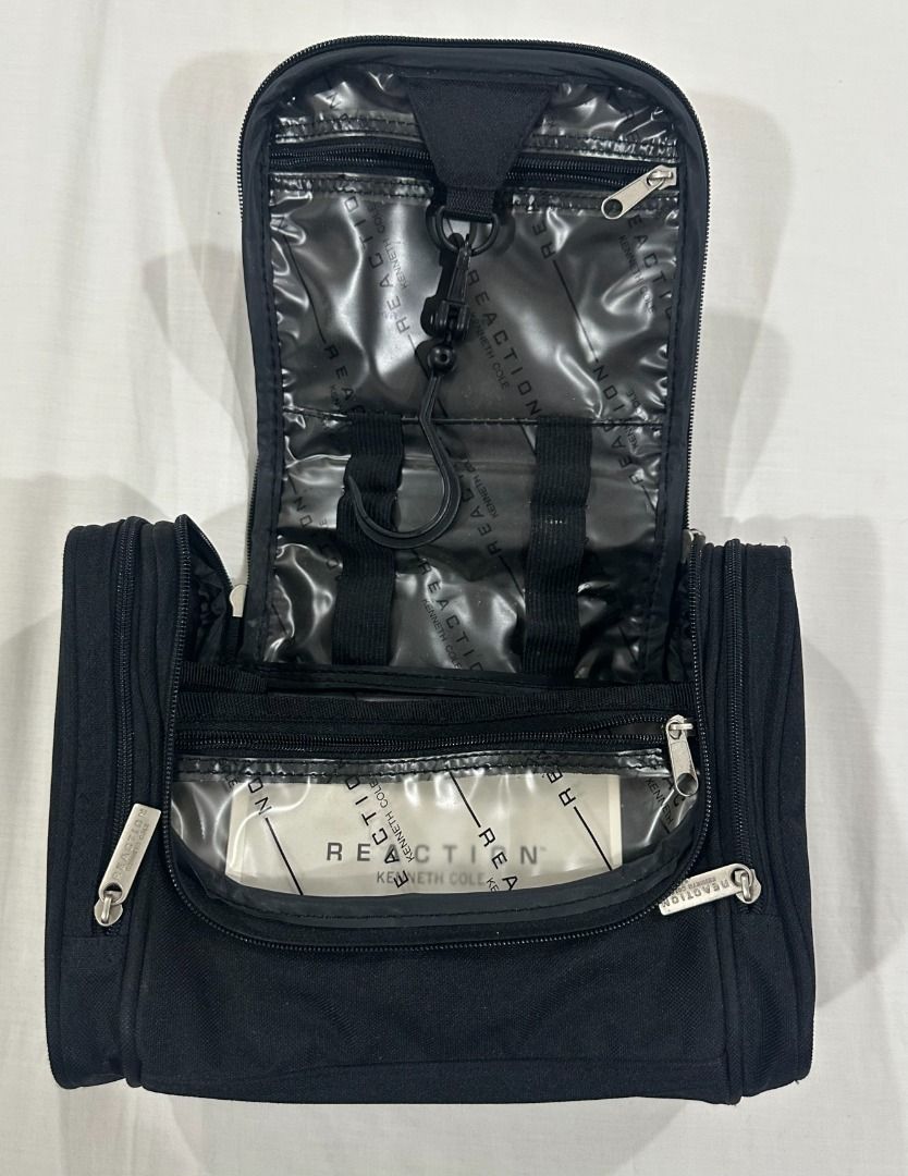 Reaction Kenneth Cole Black Toiletry Bag with Hook (Category: Belt bags, Clutches and Pouches) located in San Juan City. Submitted by looneyc (Listing ID 1461422409, Image 3). Description: - Brand: Reaction Kenneth Cole - Color: Black - Features: Multiple compartments, hanging hook - Closure: Secure zip - Ideal for: Travel, organizing essentials - Approximate Size: 10 inches wide (laid flat) WYSIWYG. ***ITEM IS AVAILABLE IF YOU CAN SEE THIS MESSA