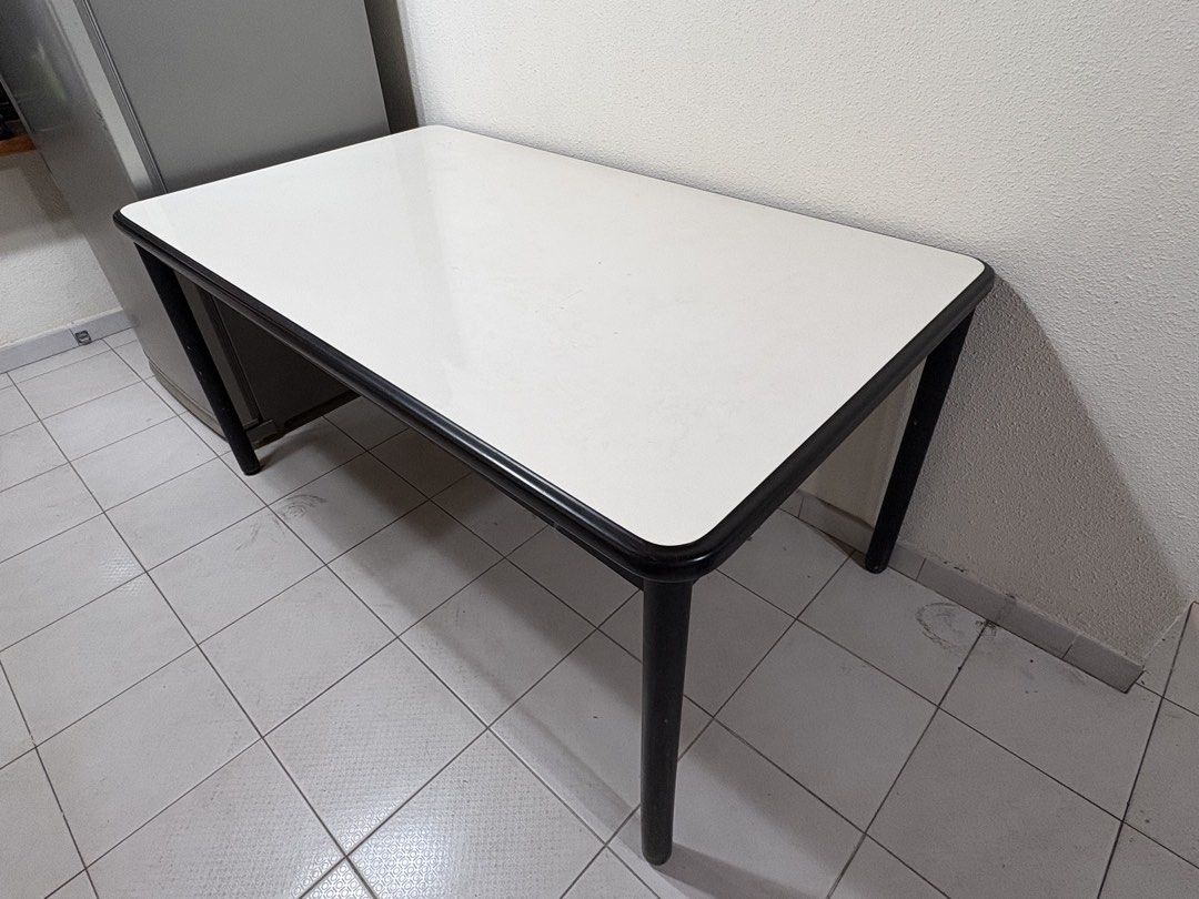 Rectangular Desk (Category: Tables & Sets) located in Singapore. Submitted by lizkoh02 (Listing ID 1461342600, Image 1). Description: - Sleek white tabletop with a sturdy black frame - Perfect size for a study or home office setup - Smooth, easy-to-clean surface - Stable and durable legs - Versatile design fits well in most room aesthetics - Made of a strong type of plastic, very easy to clean 154cm length 89cm width 75cm height.