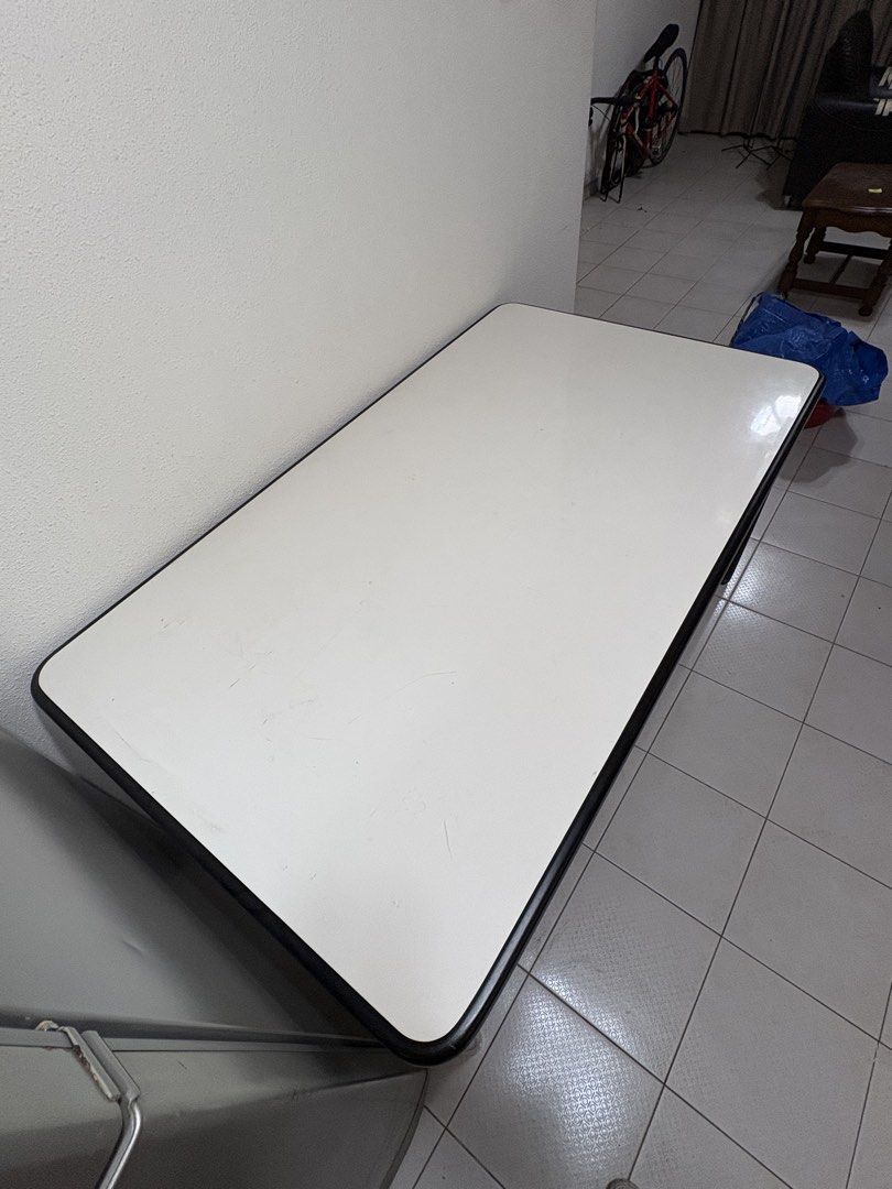 Rectangular Desk (Category: Tables & Sets) located in Singapore. Submitted by lizkoh02 (Listing ID 1461342600, Image 2). Description: - Sleek white tabletop with a sturdy black frame - Perfect size for a study or home office setup - Smooth, easy-to-clean surface - Stable and durable legs - Versatile design fits well in most room aesthetics - Made of a strong type of plastic, very easy to clean 154cm length 89cm width 75cm height.