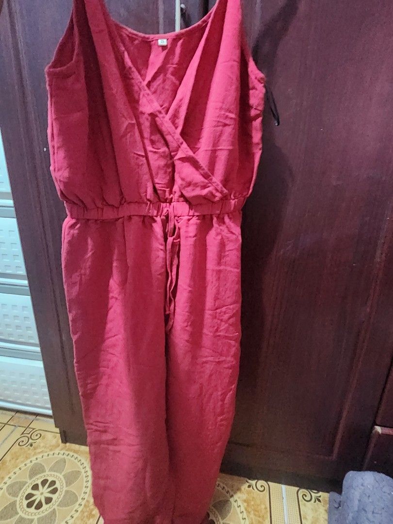 Red Wrap V-Neck jumpsuit (Category: Dresses) located in Muntinlupa City. Submitted by yanyan1888 (Listing ID 1461367994, Image 2). Description: - Flattering red wrap jumpsuit with V-neckline - Adjustable straps for a customized fit - Tie waist detail creates a cinched, flattering silhouette - Comfortable material, likely linen or a blend - Versatile: great for casual outings or as a stylish beach cover-up - Easy to wear and style for effortless f