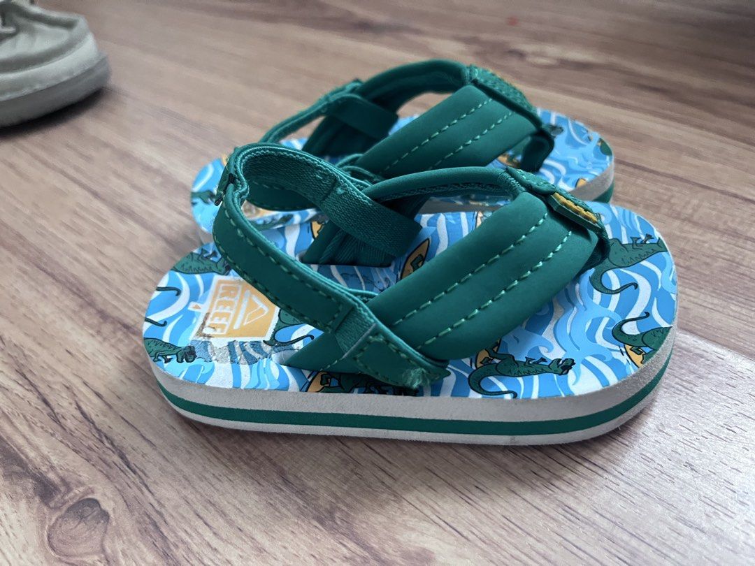 Reef Kids Flip Flops Sandals Dinosaur Pattern Blue Green (Category: Babies & Kids Fashion) located in Pasig City. Submitted by torisstuff (Listing ID 1461390439, Image 1). Description: - Cute Reef flip flops for kids - Fun dinosaur and wave pattern - Blue and green colors - Green straps with Reef logo - Perfect for beach or pool - Easy to slip on and of Size 4.