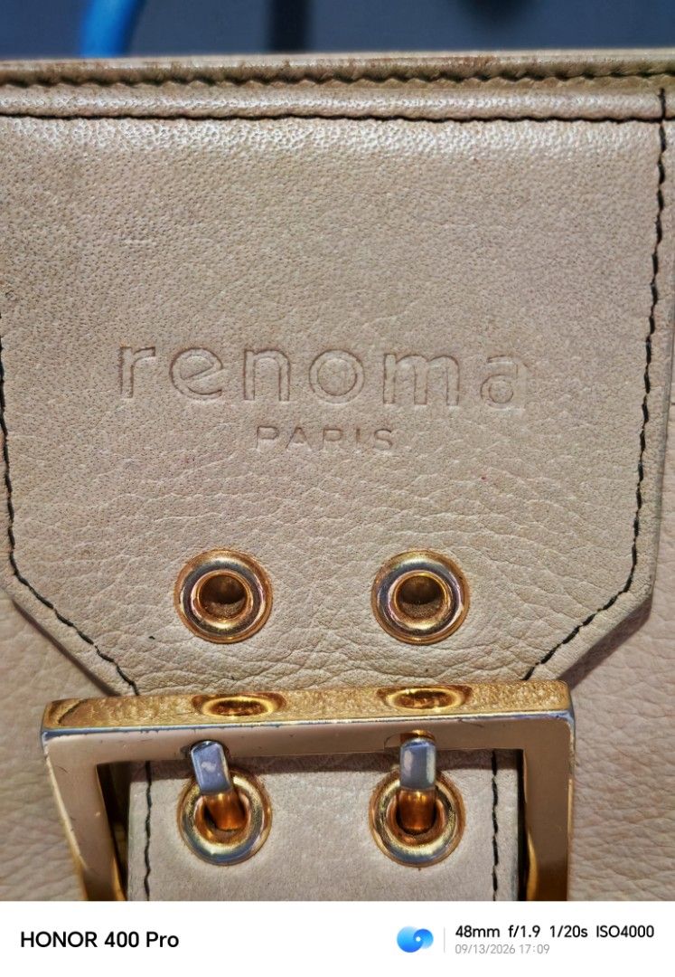 Renoma Paris Leather Shoulder Bag (Category: Luxury Bags & Wallets) located in Manila. Submitted by cleverwhale_45b7bc (Listing ID 1461429265, Image 2). Description: - Renoma Paris tan leather shoulder bag - Features a gold buckle closure on the front flap - Convenient zip pocket on the back - Adjustable strap for comfortable wear - Minor signs of wear on leather and hardware, adding character - Interior is clean and well-maintained.