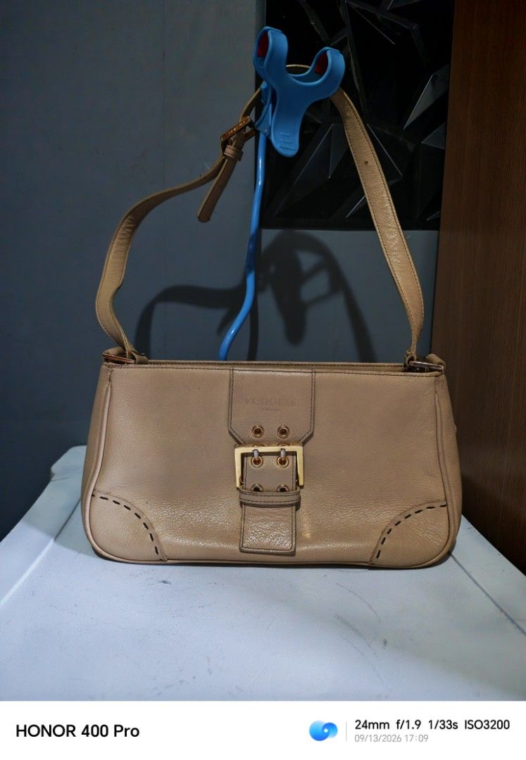 Renoma Paris Leather Shoulder Bag (Category: Luxury Bags & Wallets) located in Manila. Submitted by cleverwhale_45b7bc (Listing ID 1461429265, Image 1). Description: - Renoma Paris tan leather shoulder bag - Features a gold buckle closure on the front flap - Convenient zip pocket on the back - Adjustable strap for comfortable wear - Minor signs of wear on leather and hardware, adding character - Interior is clean and well-maintained.