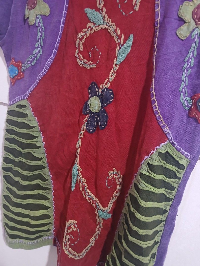 Rising International Patchwork Embroidered T-shirt Size M (Category: Tshirts & Polo Shirts ) located in Taguig. Submitted by thriftnilhan (Listing ID 1461391511, Image 2). Description: - Unique patchwork design from Rising International. - Eye-catching red center panel with embroidered vines and a black flower. - Vibrant purple sleeves and sides adorned with floral appliques. - Contrasting green ribbed panels on the sides for added detail. - Size