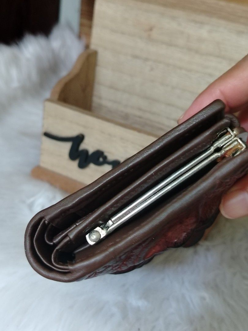 River Crocodile embossed Small Wallet (Category: Wallets & Card holders) located in Lucena. Submitted by gracious_chin0436 (Listing ID 1461327878, Image 3). Description: - Genuine brown crocodile skin exterior - Secure metal clasp closure - Dark brown leather interior - Compact and practical size - Shows minor signs of wear on clasp and edges, but still functional and stylish.