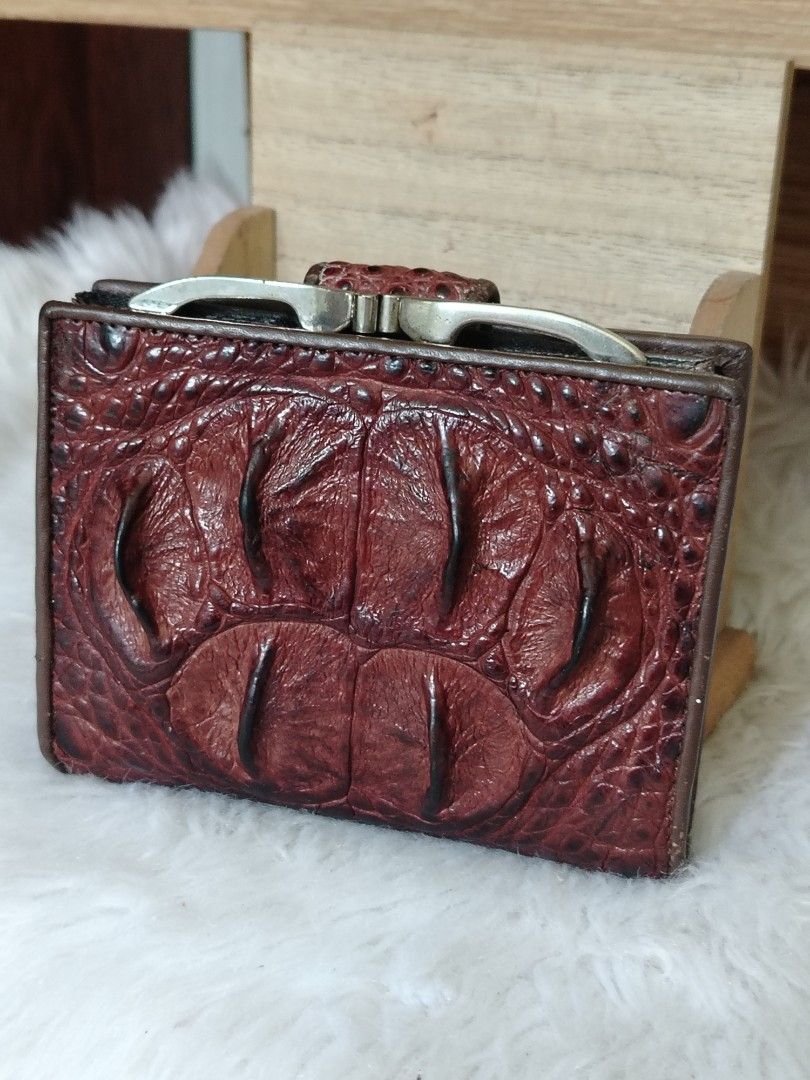 River Crocodile embossed Small Wallet (Category: Wallets & Card holders) located in Lucena. Submitted by gracious_chin0436 (Listing ID 1461327878, Image 2). Description: - Genuine brown crocodile skin exterior - Secure metal clasp closure - Dark brown leather interior - Compact and practical size - Shows minor signs of wear on clasp and edges, but still functional and stylish.