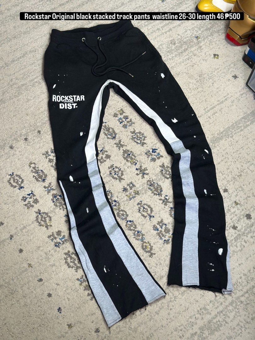 Rockstar Original Black Stacked Track Pants (Category: Other Bottoms) located in Daet. Submitted by thrifthings2018 (Listing ID 1461406801, Image 1). Description: - Brand: Rockstar Dist. - Color: Black - Style: Stacked Track Pants - Waistline: Fits 26-30 inches - Length: 46 inches - Details: White paint splatters, grey stripe down legs - Perfect for: Casual wear.