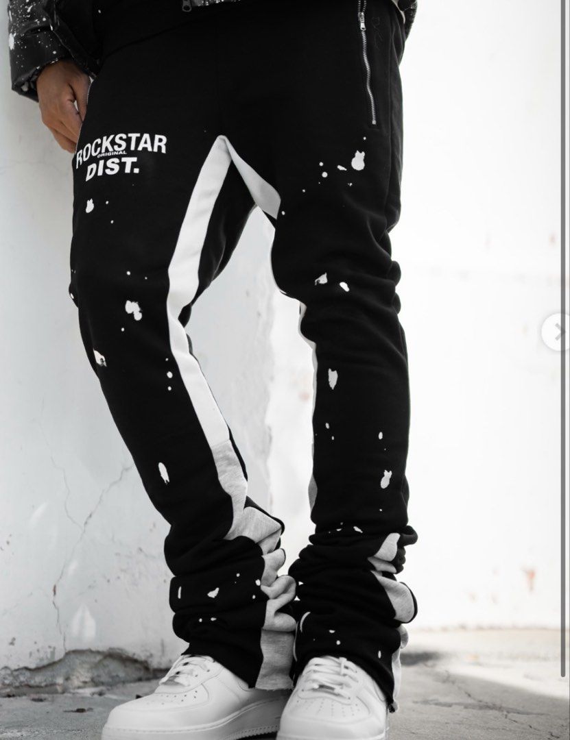 Rockstar Original Black Stacked Track Pants (Category: Other Bottoms) located in Daet. Submitted by thrifthings2018 (Listing ID 1461406801, Image 2). Description: - Brand: Rockstar Dist. - Color: Black - Style: Stacked Track Pants - Waistline: Fits 26-30 inches - Length: 46 inches - Details: White paint splatters, grey stripe down legs - Perfect for: Casual wear.