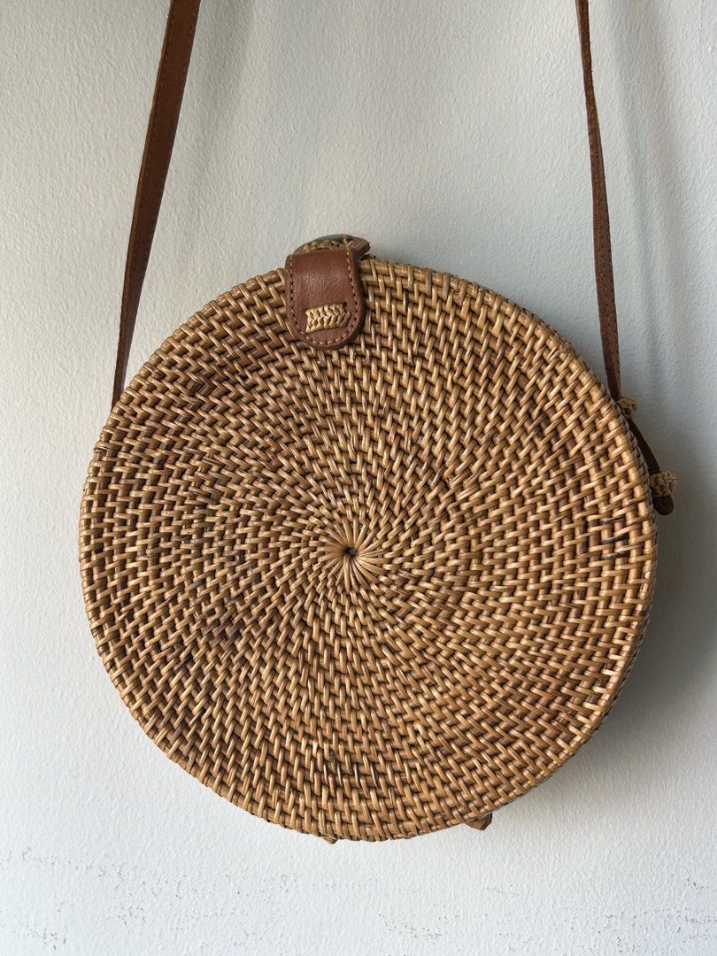 Round Rattan Bag with Leather Strap (Category: Cross-body Bags) located in Quezon City. Submitted by hygge.elements (Listing ID 1461345309, Image 1). Description: - Cute round rattan bag - Natural woven material - Brown leather strap and closure - Lined with blue and orange floral fabric - Ideal for beach trips or casual outings - Unique boho style.