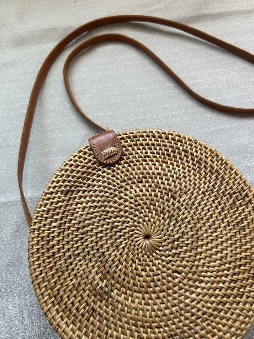 Round Rattan Bag with Leather Strap (Category: Cross-body Bags) located in Quezon City. Submitted by hygge.elements (Listing ID 1461345309, Image 2). Description: - Cute round rattan bag - Natural woven material - Brown leather strap and closure - Lined with blue and orange floral fabric - Ideal for beach trips or casual outings - Unique boho style.