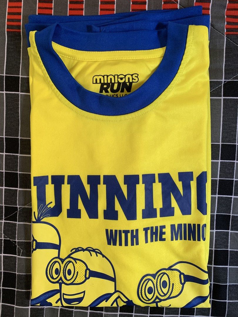 Running with the Minion Run (Category: Activewear) located in Taguig. Submitted by ahnjr (Listing ID 1461430711, Image 3). Description: - Product: "Running with the Minion Run" T-shirt - Size: S (EU 48/UK 38/US 38) - Color: Yellow - Design: Features "Running with the Minions" graphic and "Be Fast or Be Last" slogan on the front. - Event Detail: "Minions Run 2025 Philippines" printed on the back. - Meetup Location: Vista Mall Taguig, Cayetano Blvd
